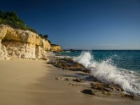 This is Cupecoy Beach where my sandals, and almost much more, were washed out to sea. As you come down the stairs (to the left of me here) there were people to the right so we thought we&#39;d get our own section of beach by going to the left. We set our stuff down just around the first outcrop of rock and prepared to enjoy ourselves. Two guys came to look at what we were doing there which I thought was a little wierd but didn&#39;t worry too much. Just about then quite a large wave rolled in right up to the cliff face. Both of my sandals, one of Paula&#39;s and the sunblock were washed out to sea and my camera bag with about $1500 worth of gear in it was submerged. Of course I grabbed the camera stuff and was thankful the bag was zipped up. One of the guys that had checked on us before retrieved Paula&#39;s sandal but the rest was gone. I guess that&#39;s why no one was there! We moved over to the other section where the rest of the non-idiots were.